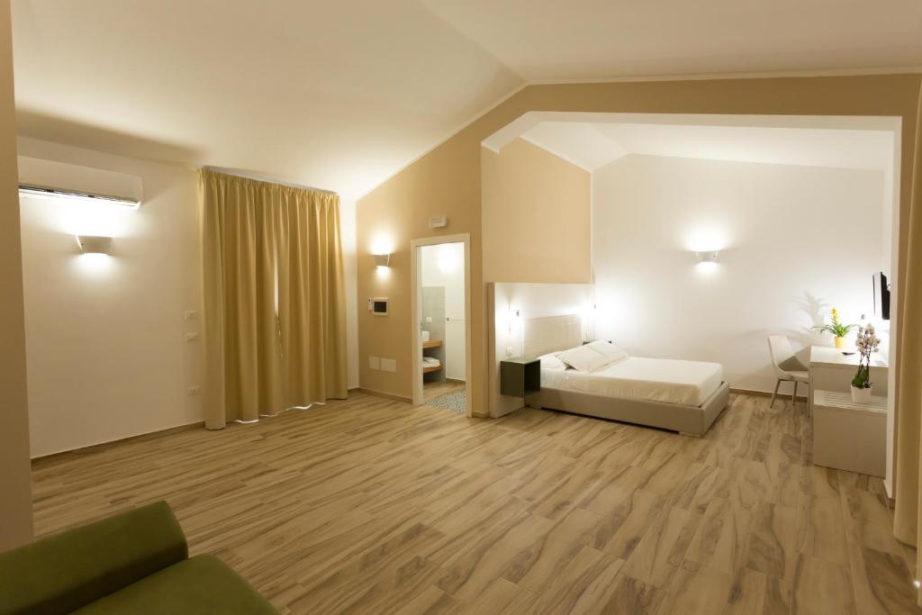 Posteľ alebo postele v izbe v ubytovaní Oasi Guzzetta Hotel&Case Vacanze
