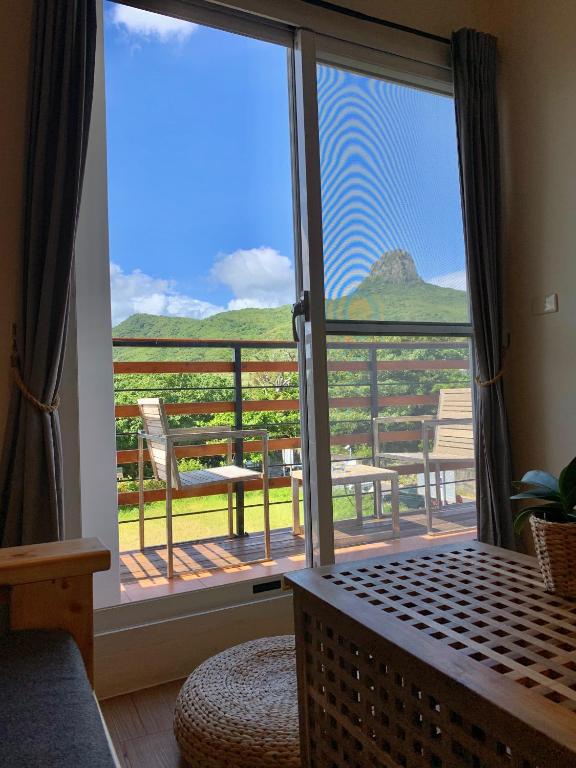 a room with a large sliding glass door with a view at W24墾丁民宿墾丁大街一館bnb in Kenting