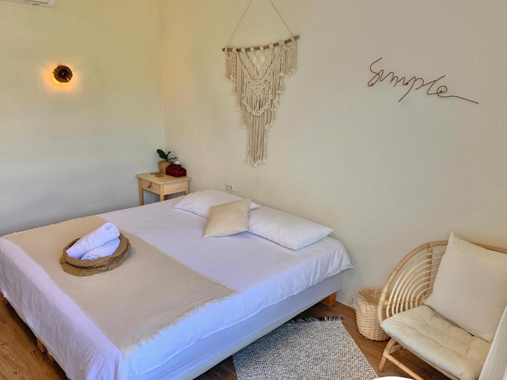 a small bedroom with a bed and a chair at W24墾丁民宿墾丁大街一館bnb in Kenting