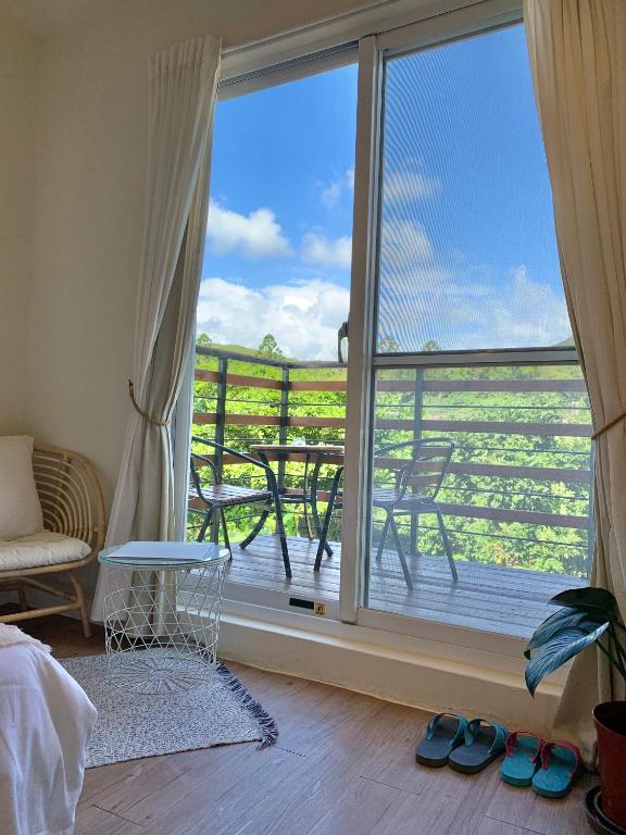 a room with a balcony with a large window at W24墾丁民宿墾丁大街一館bnb in Kenting