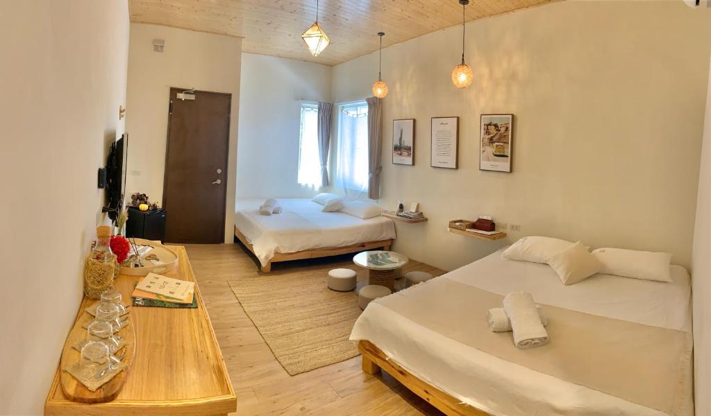 a room with two beds and a table in it at W24墾丁民宿墾丁大街一館bnb in Kenting