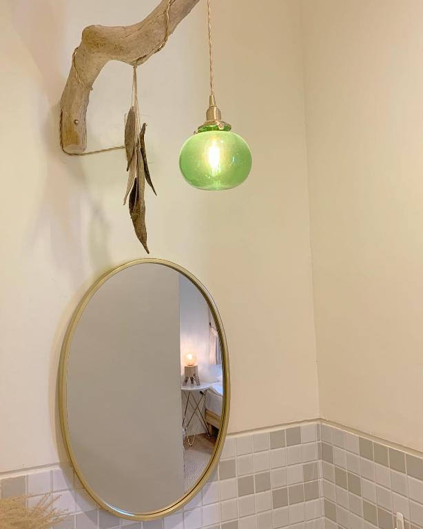 a bathroom with a mirror and a light and a lamp at W24墾丁民宿墾丁大街一館bnb in Kenting