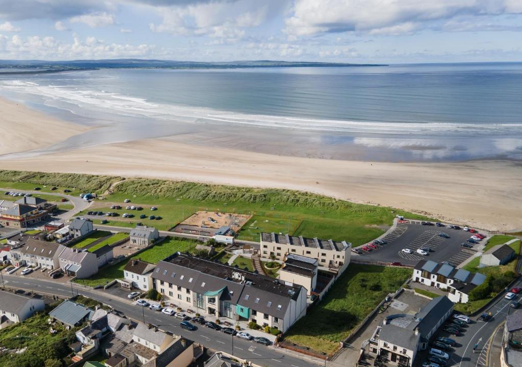 an aerial view of a resort and the beach at Ocean Sands Hotel in Enniscrone