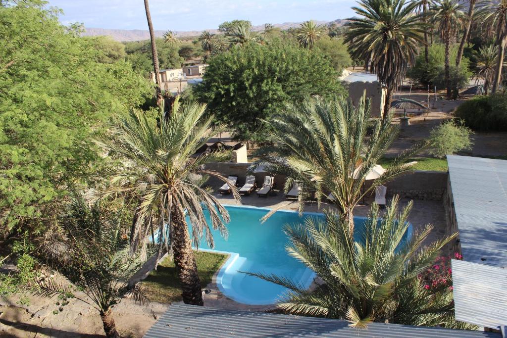 una vista aérea de una piscina con palmeras en Fort Sesfontein Lodge & Safaris, en Sesfontein