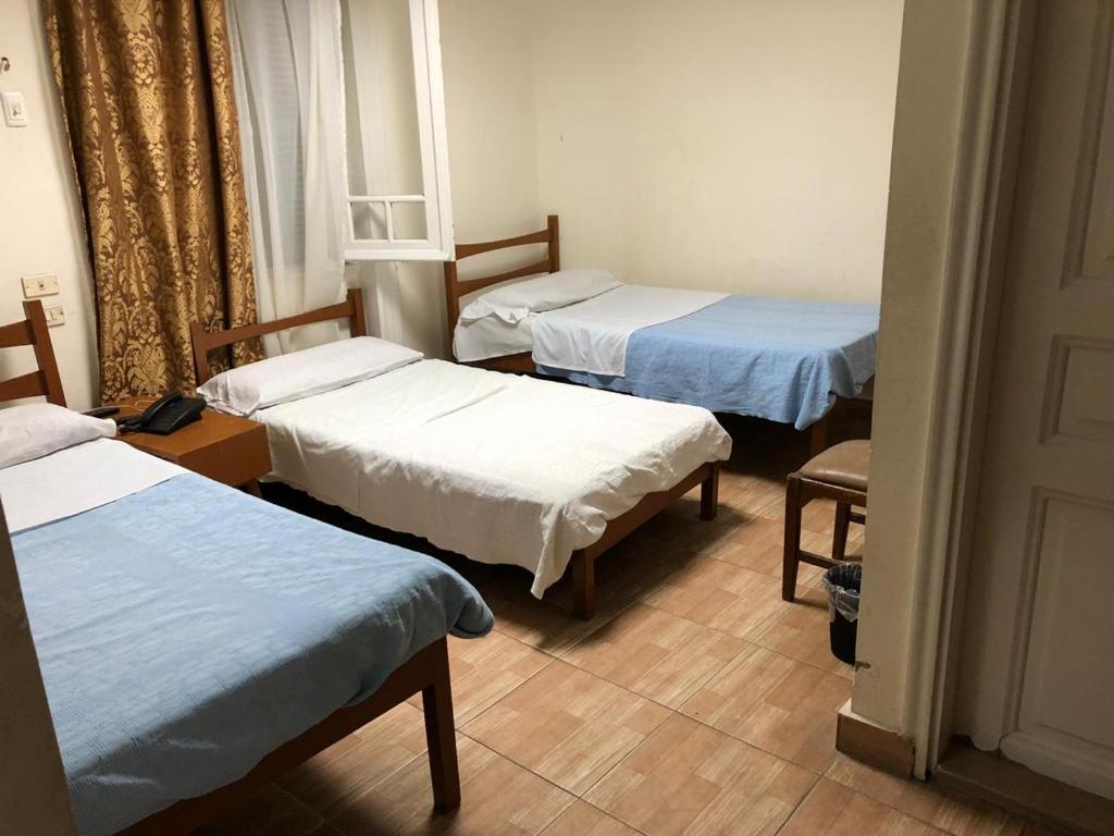 Postel nebo postele na pokoji v ubytování Tulip Hotel