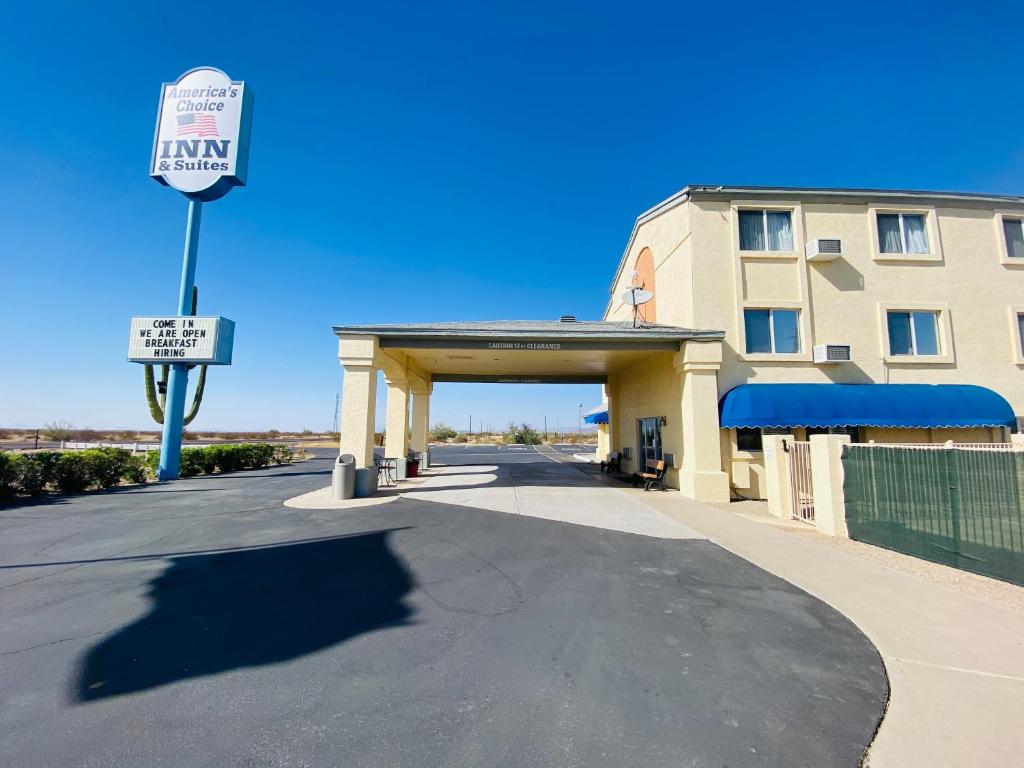 a building with a street sign next to a building at Americas Choice Inn & Suites in Gila Bend