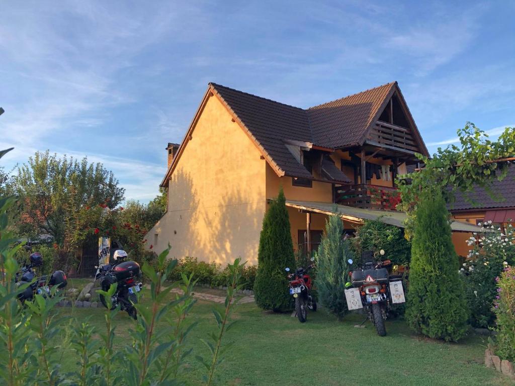 a group of motorcycles parked in front of a house at Casa Ardeleneasca in Sebeşu de Sus