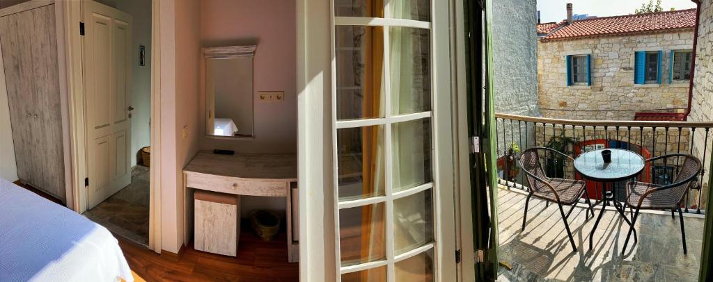 a room with a view of a balcony with a bed at Oberj d'Azur Alaçatı in Alaçatı