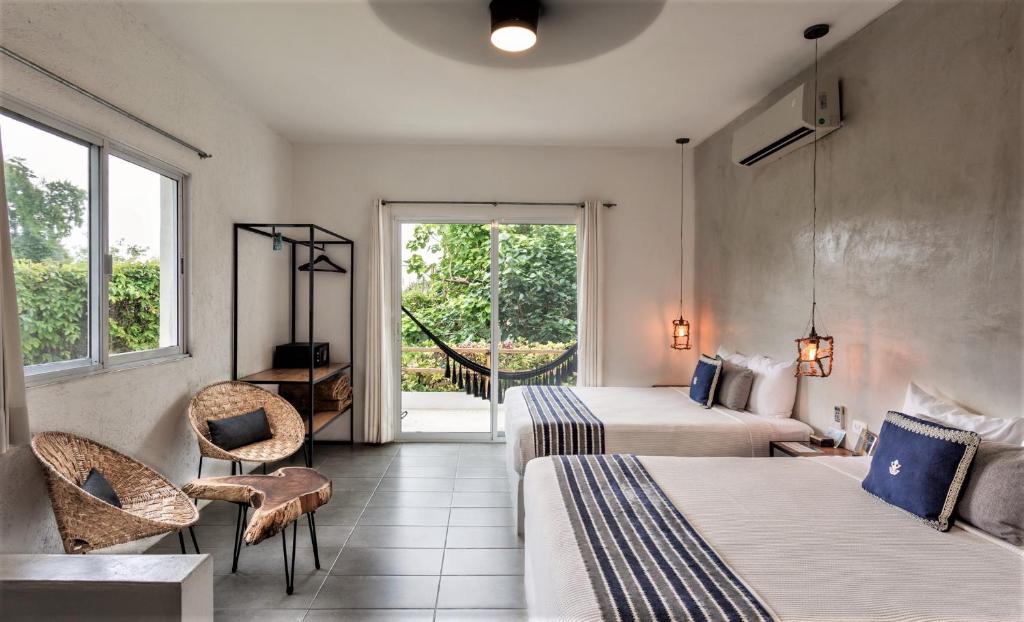 Postel nebo postele na pokoji v ubytování Hotel Aires Bacalar