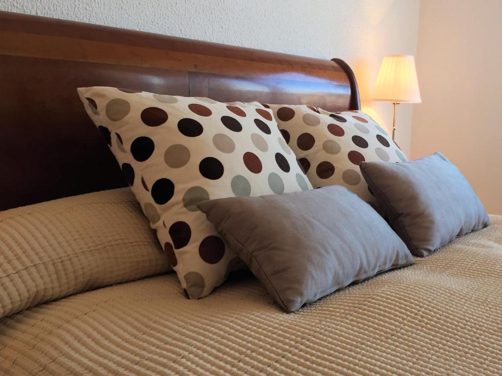 a bed with polka dots and pillows on it at Apartment Ronda City Center in Ronda