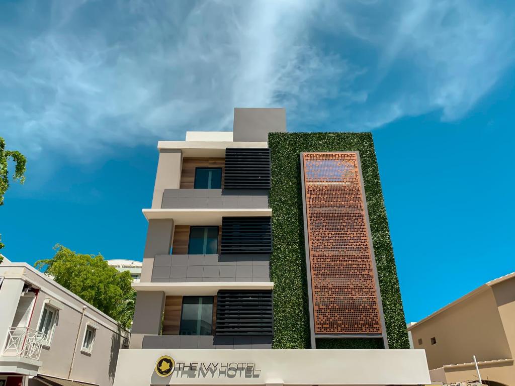 a building with a wall of ivy on it at The Ivy Hotel in San Juan