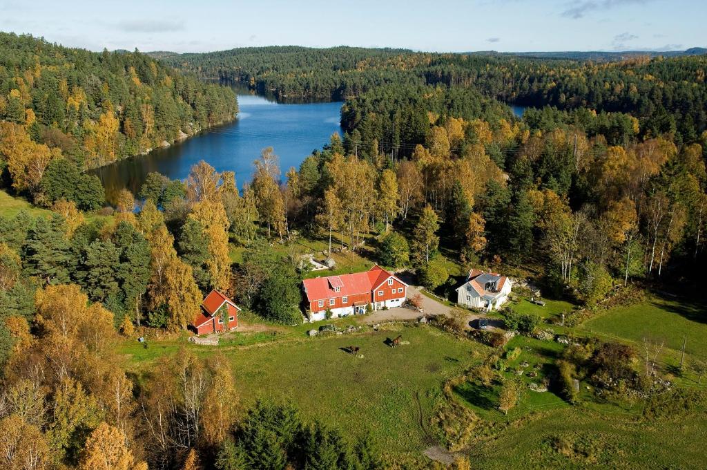 an aerial view of a house on a hill next to a lake at Finas Torpgård B&K in Gällinge