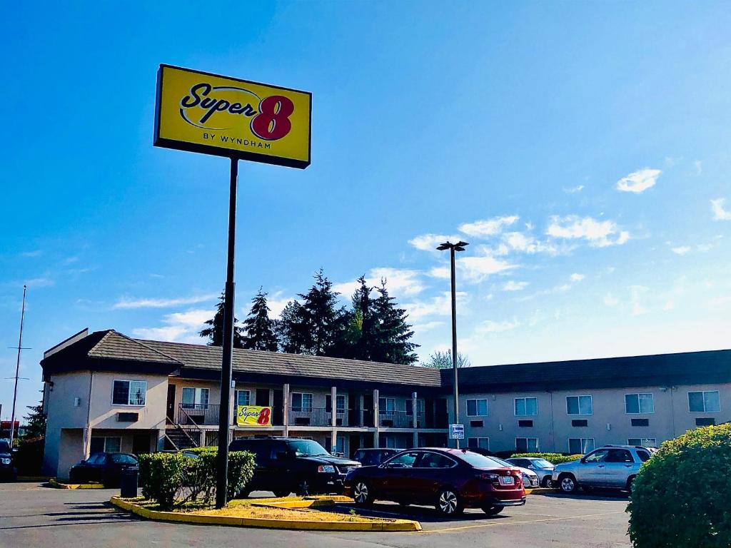 a sign for a super motel in a parking lot at Super 8 by Wyndham Lynnwood in Lynnwood