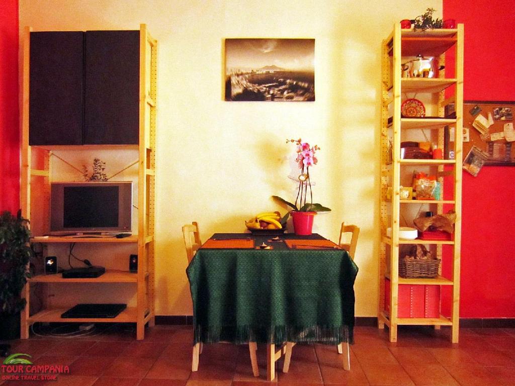 a dining room with a table and a television at B&B Historic Centre Naples in Naples