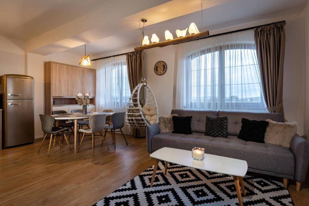 a living room with a couch and a table at GOLDENapartment in Veľká Lomnica
