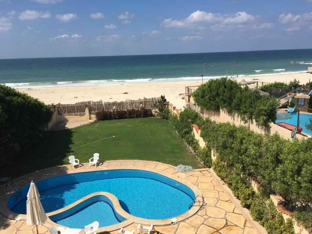 a view of a swimming pool and the beach at North Coast Villa sea view with private pool in Alexandria