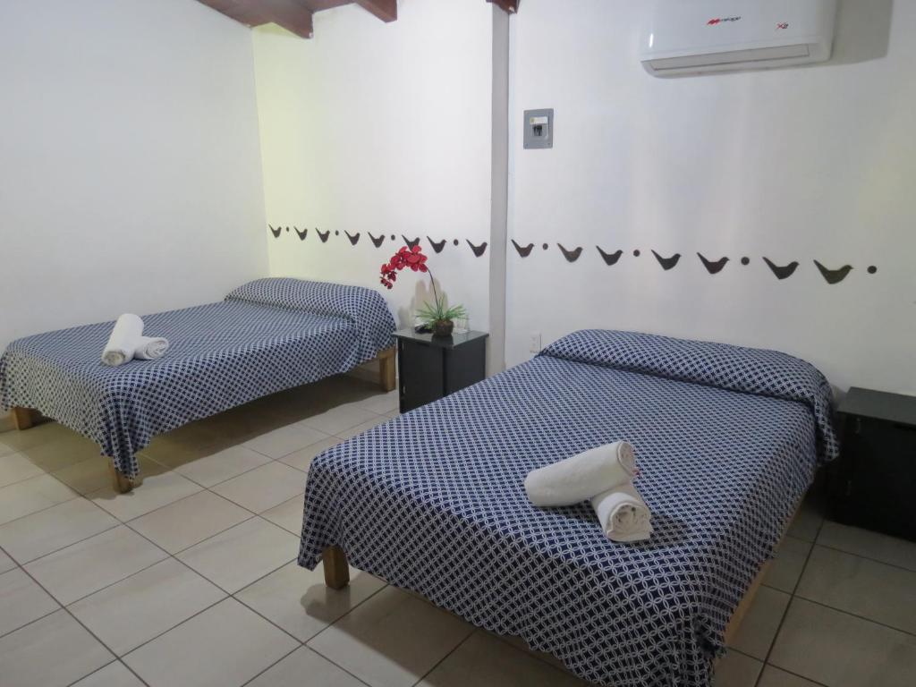 Postel nebo postele na pokoji v ubytování Hotel Posada Comala