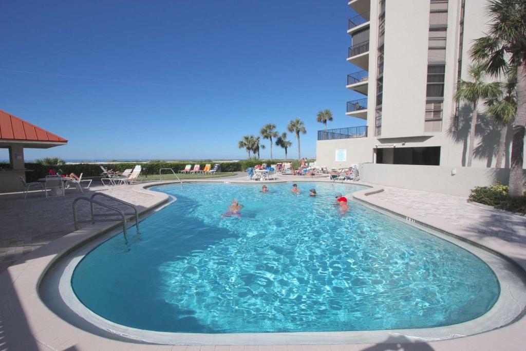 a swimming pool at a hotel with people in it at 1208 Lighthouse Towers in Clearwater Beach