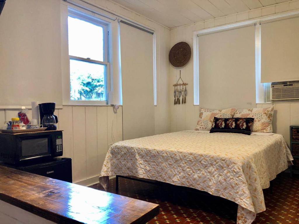 a bedroom with a bed and a clock on the wall at Private Studio with Free Parking - 7G in Miami