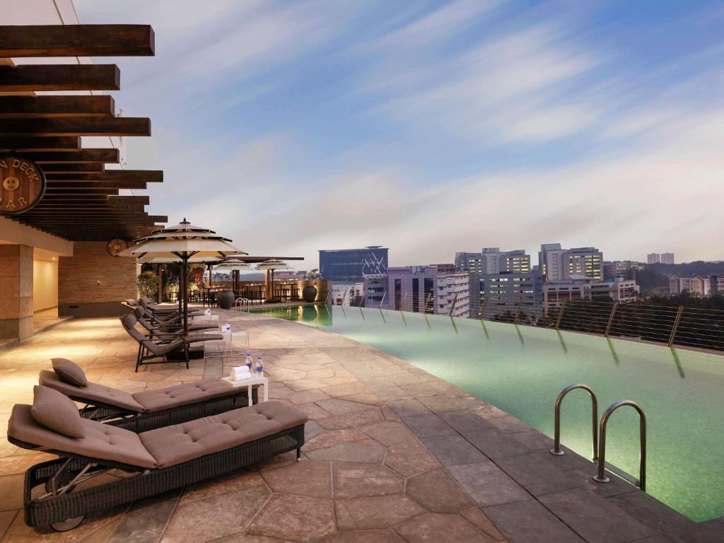 a swimming pool on the roof of a building at Novotel Kochi Infopark in Cochin