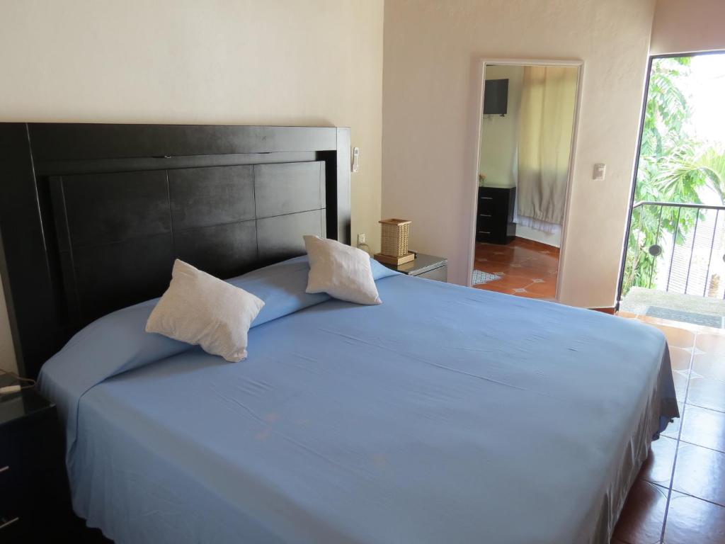 Postel nebo postele na pokoji v ubytování Hotel Posada Comala