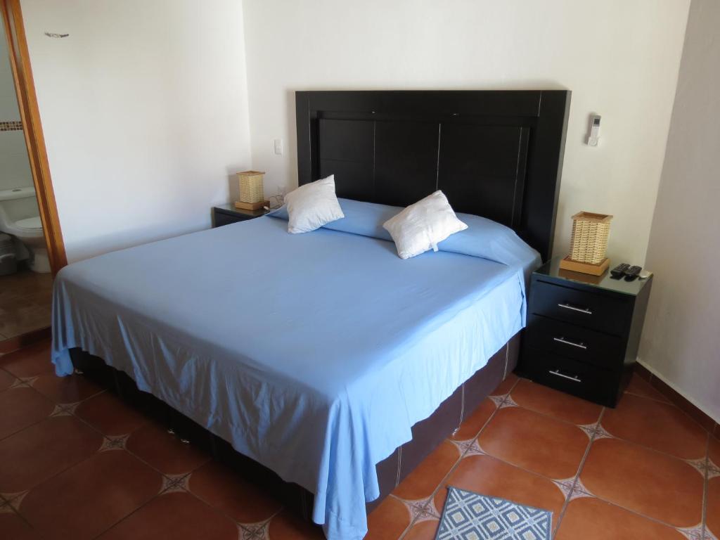 Postel nebo postele na pokoji v ubytování Hotel Posada Comala