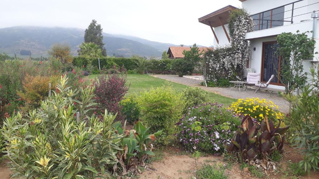 a garden in front of a house with flowers at Callihue Lodge in Santa Cruz