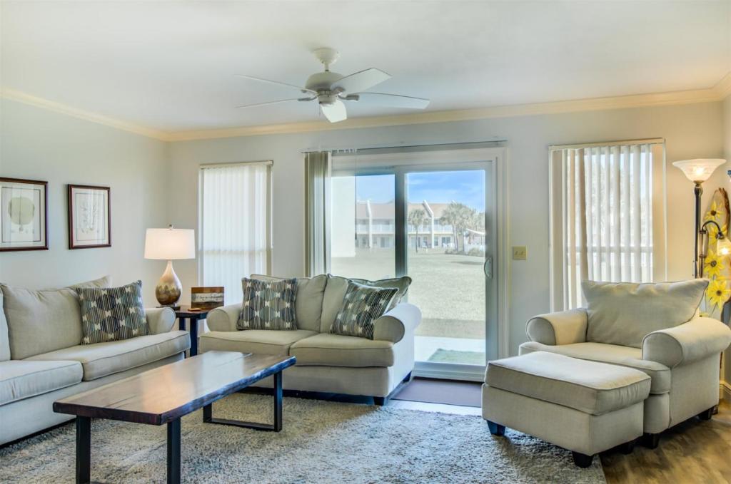 a living room with two couches and a table at 10 A, One Bedroom Condo in Destin