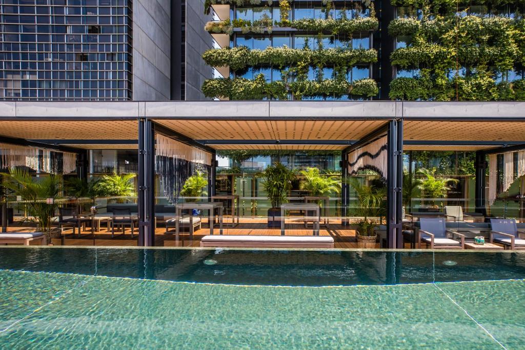 a building with tables and chairs in front of it at The Old Clare Hotel, Independent Collection by EVT in Sydney