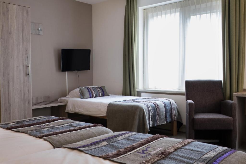 Postel nebo postele na pokoji v ubytování Landgoedhotel Woodbrooke Barchem