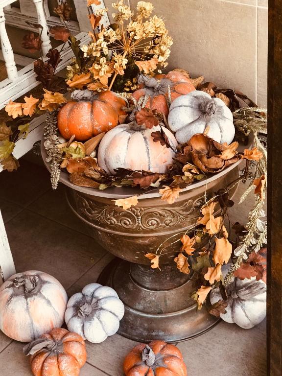 a bowl full of pumpkins sitting on the ground at Hostal Boutique Plaza Cantarero in Nerja