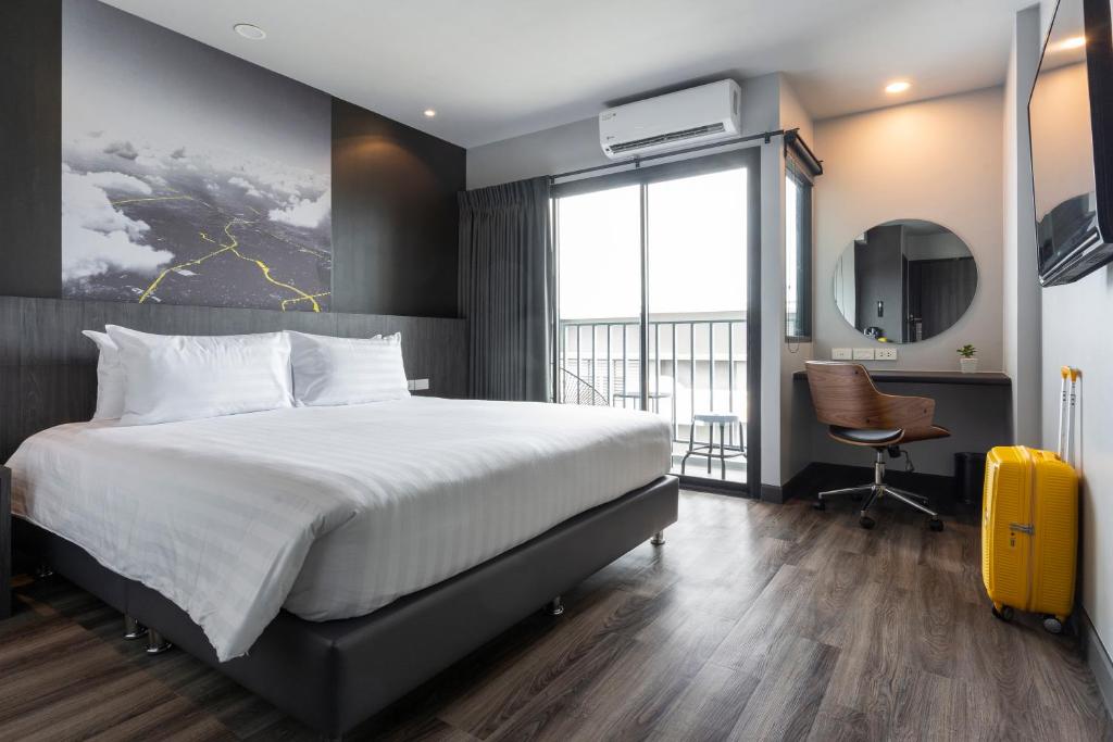 En eller flere senge i et værelse på Sleep Mai Chiang Mai Airport Lifestyle Hotel - SHA Plus