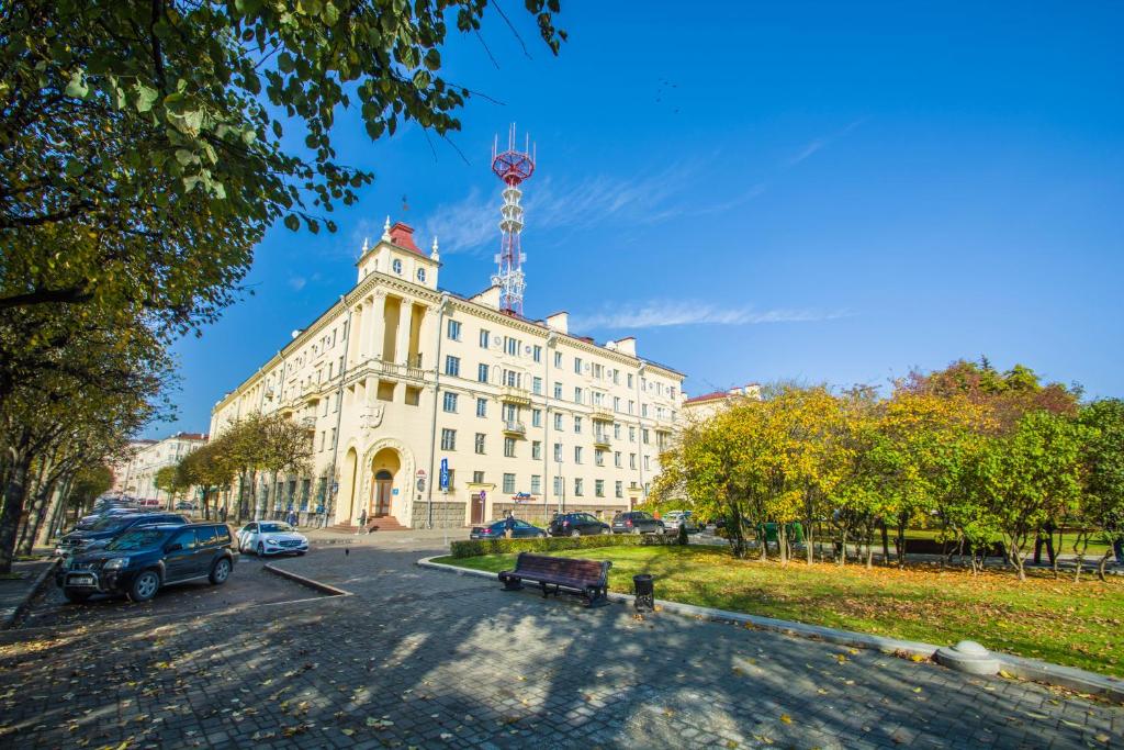 a large white building with a clock tower on top of it at iRent.by in Minsk