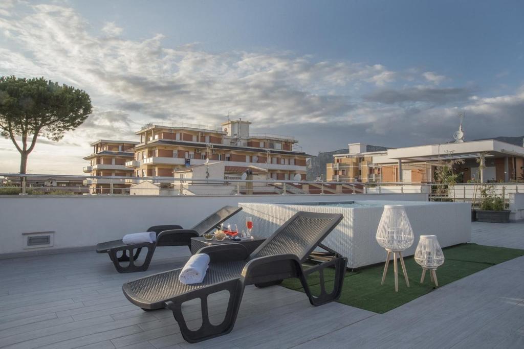 a hotel room with a lawn chair and patio at Acca residence in Terracina