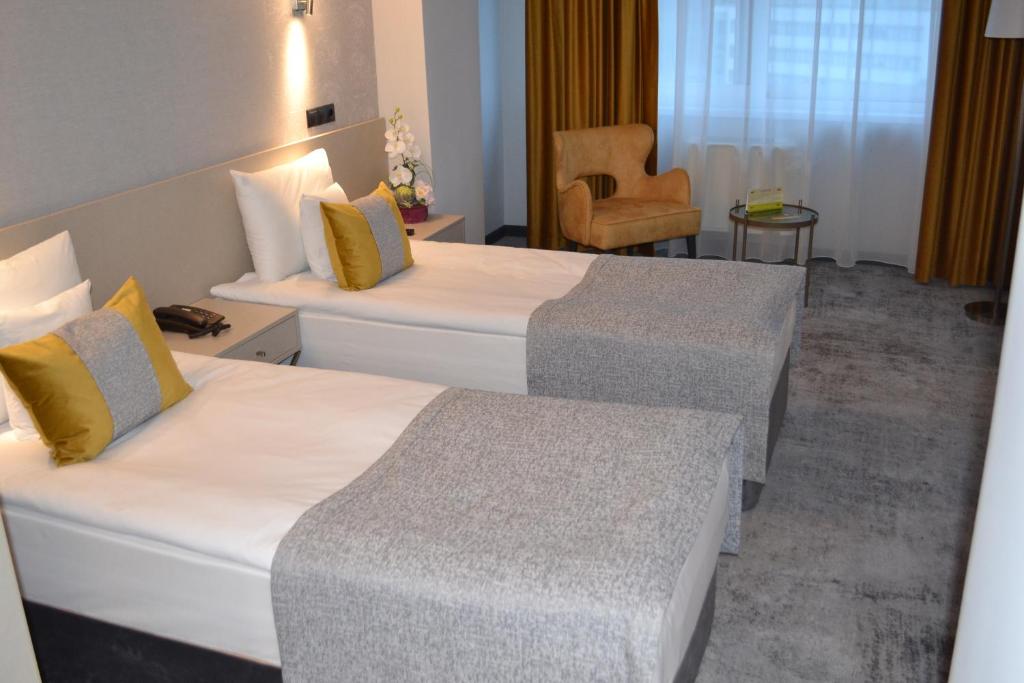 Postel nebo postele na pokoji v ubytování Hotel Univers