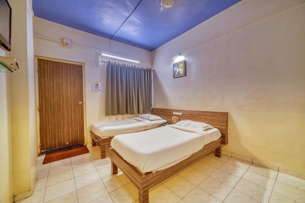 Postel nebo postele na pokoji v ubytování Hotel Grand Ashwin