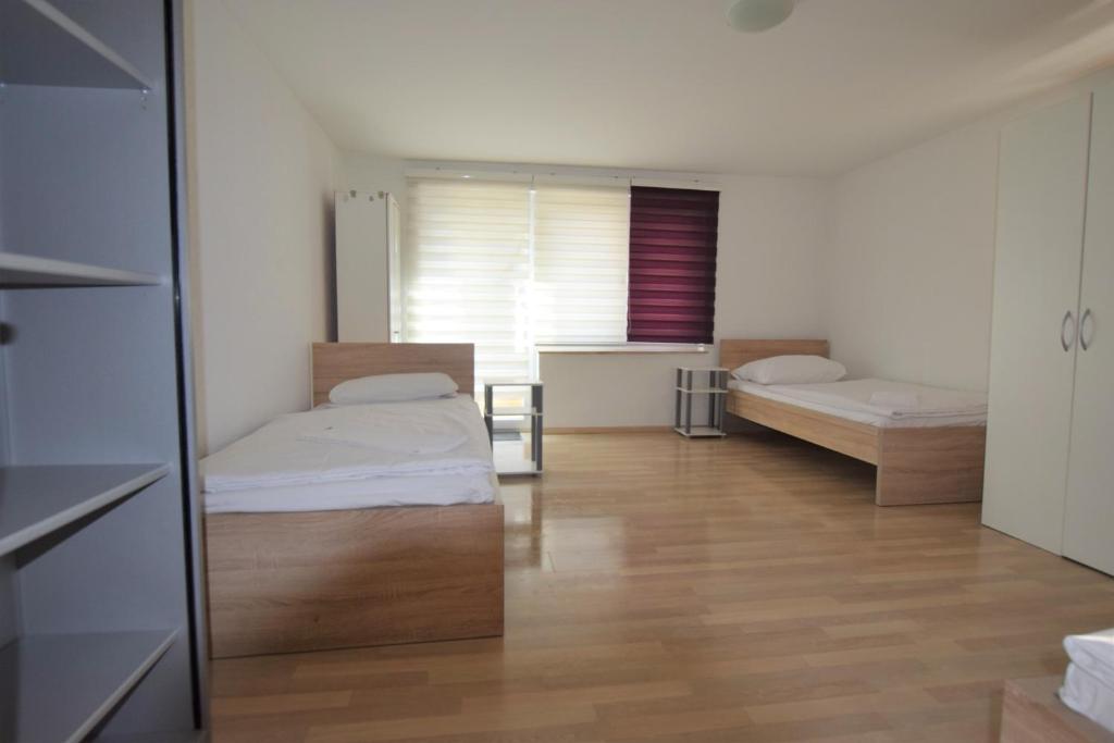 a room with two beds and a window in it at Apartment Ostfildern in Ostfildern