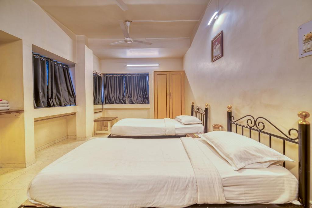 Postel nebo postele na pokoji v ubytování Hotel Grand Ashwin