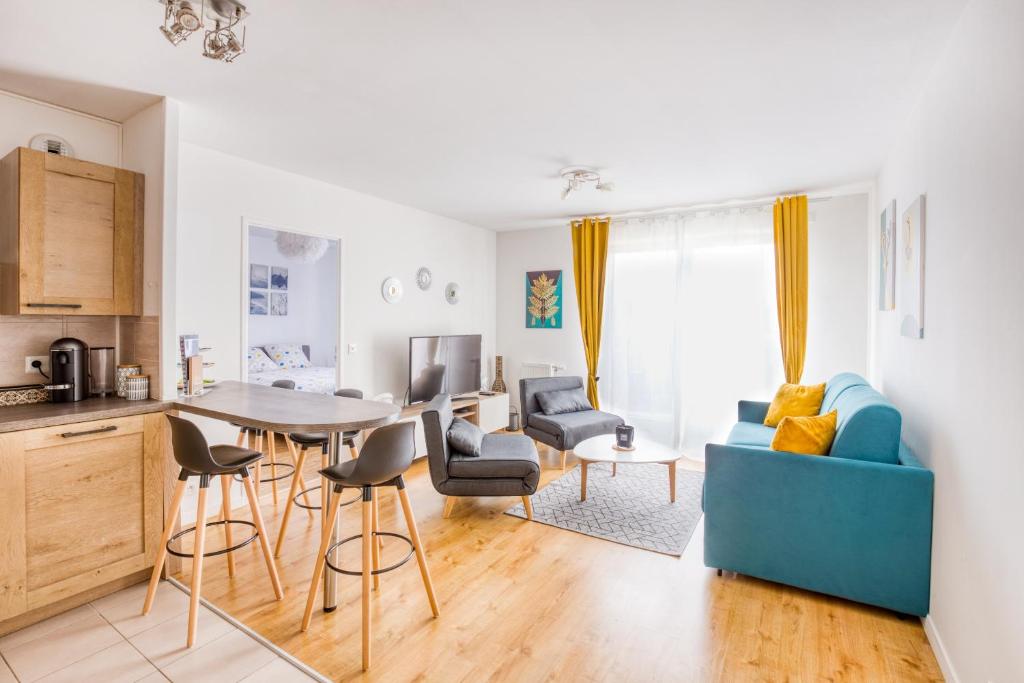 a kitchen and living room with a table and chairs at J-Mo Home - Chessy - Magnifique vue sur le château in Chessy