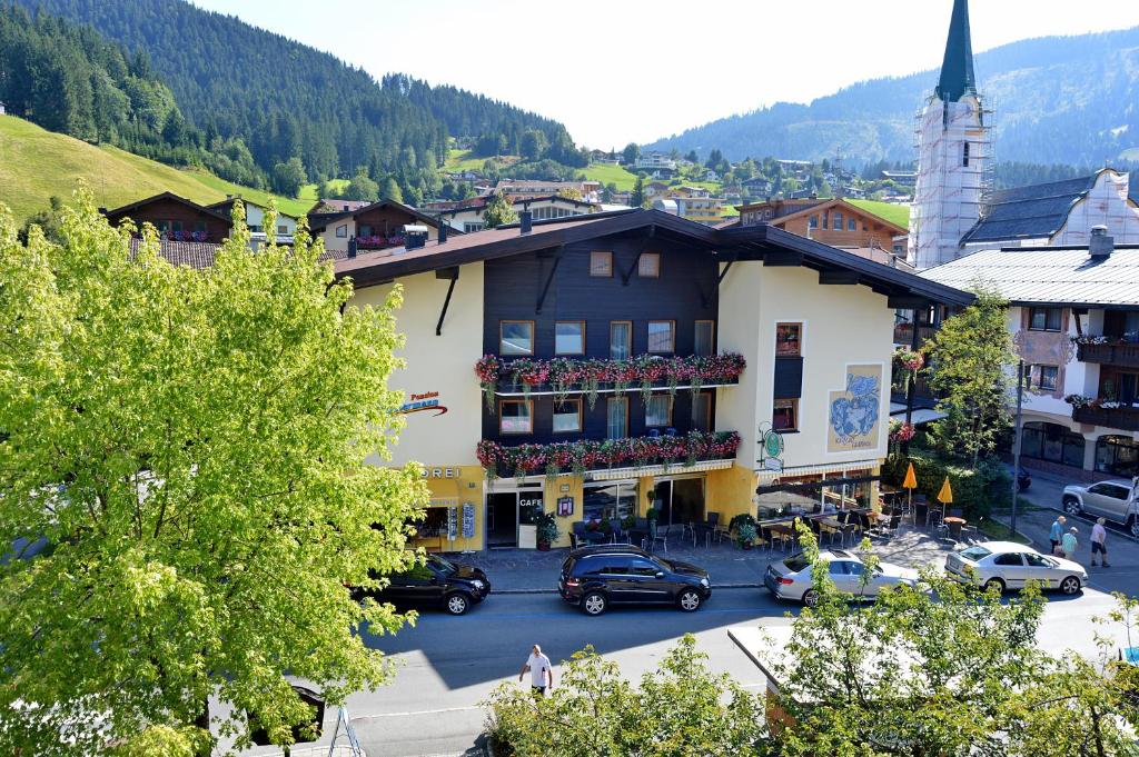 a town with cars parked in a parking lot at Café-Pension Kaisermann in Ellmau