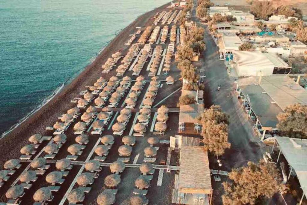 an aerial view of a parking lot with umbrellas at Dodo's Perivolos in Perivolos