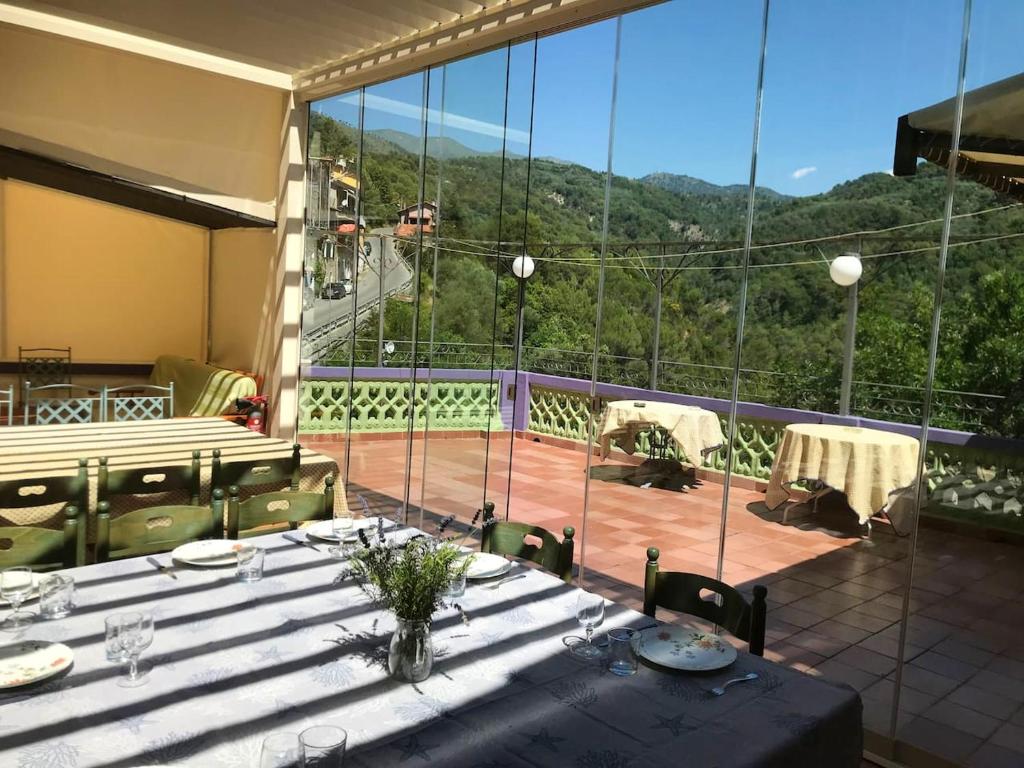 a table and chairs on a balcony with a view at 6 bedrooms house with furnished terrace and wifi at Olivetta in Olivetta