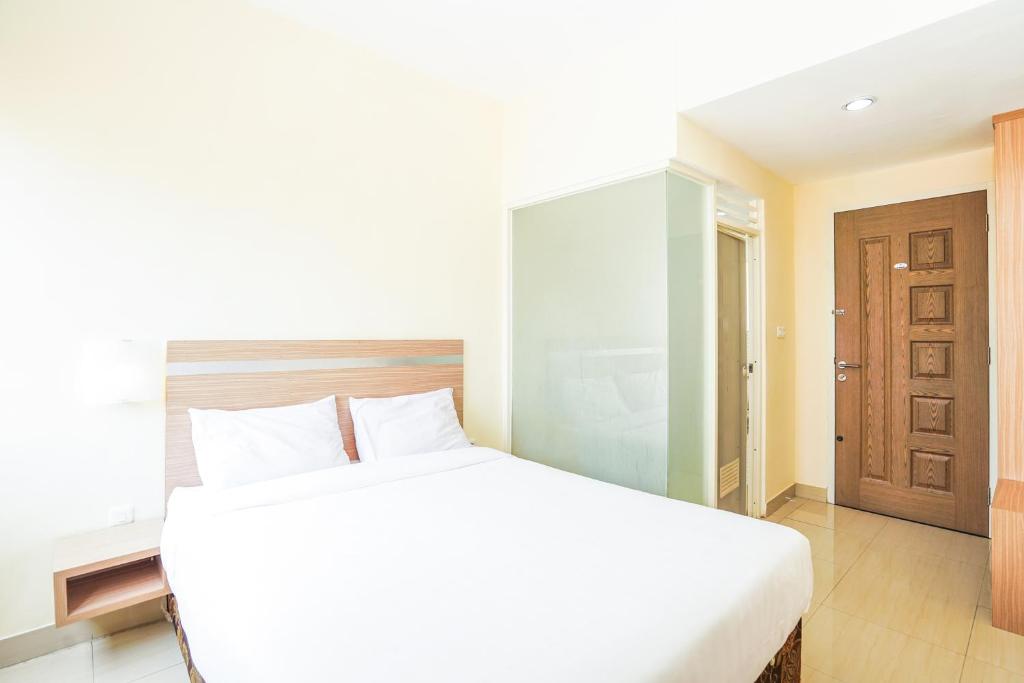 Postel nebo postele na pokoji v ubytování Pratisarawirya Guesthouse by ecommerceloka