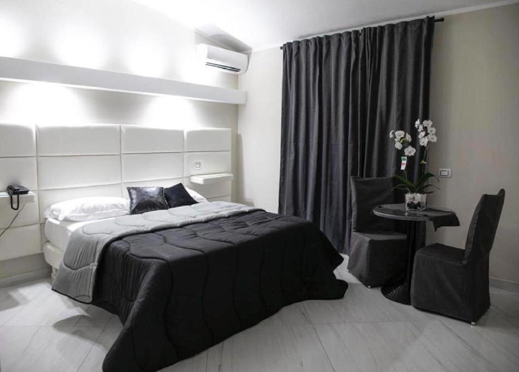 Postel nebo postele na pokoji v ubytování Hotel Trionfal