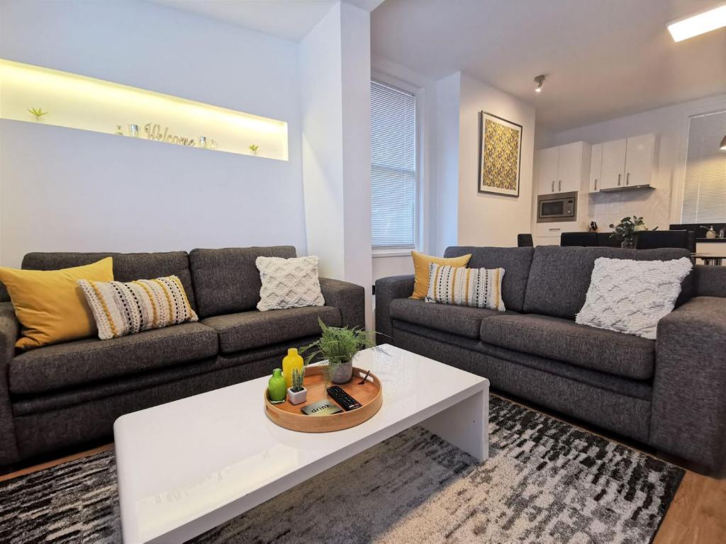 a living room with two couches and a coffee table at Hobart Cityscape in Hobart