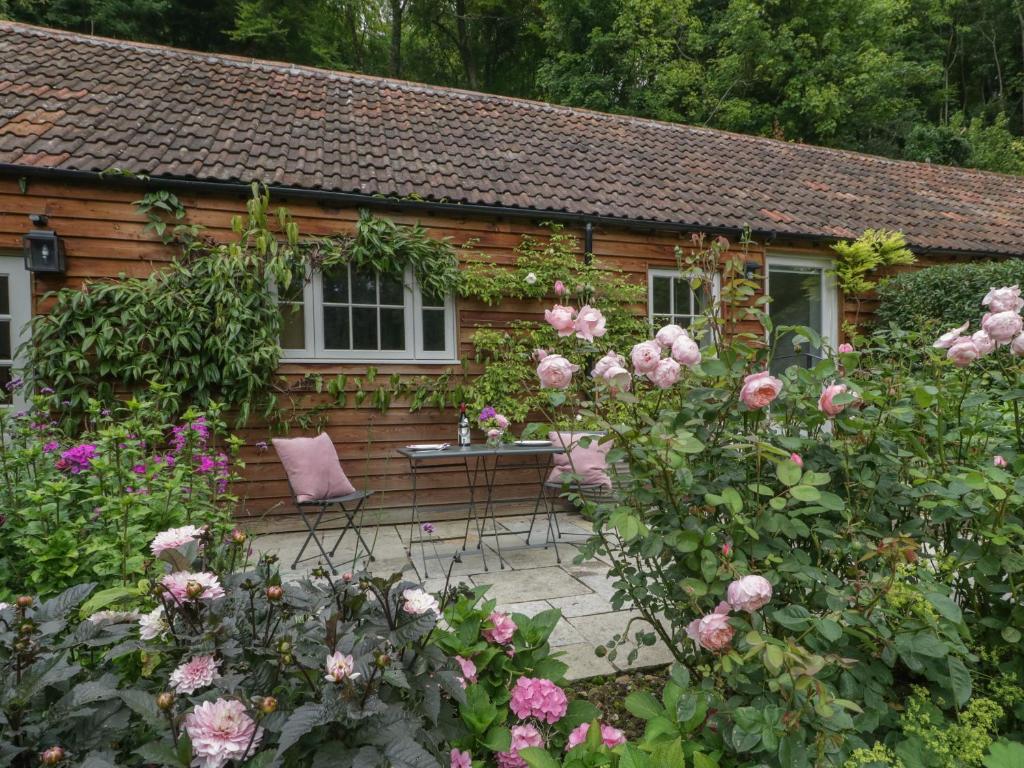 a cottage with roses in front of it at Barn Owl Cottage in Salisbury
