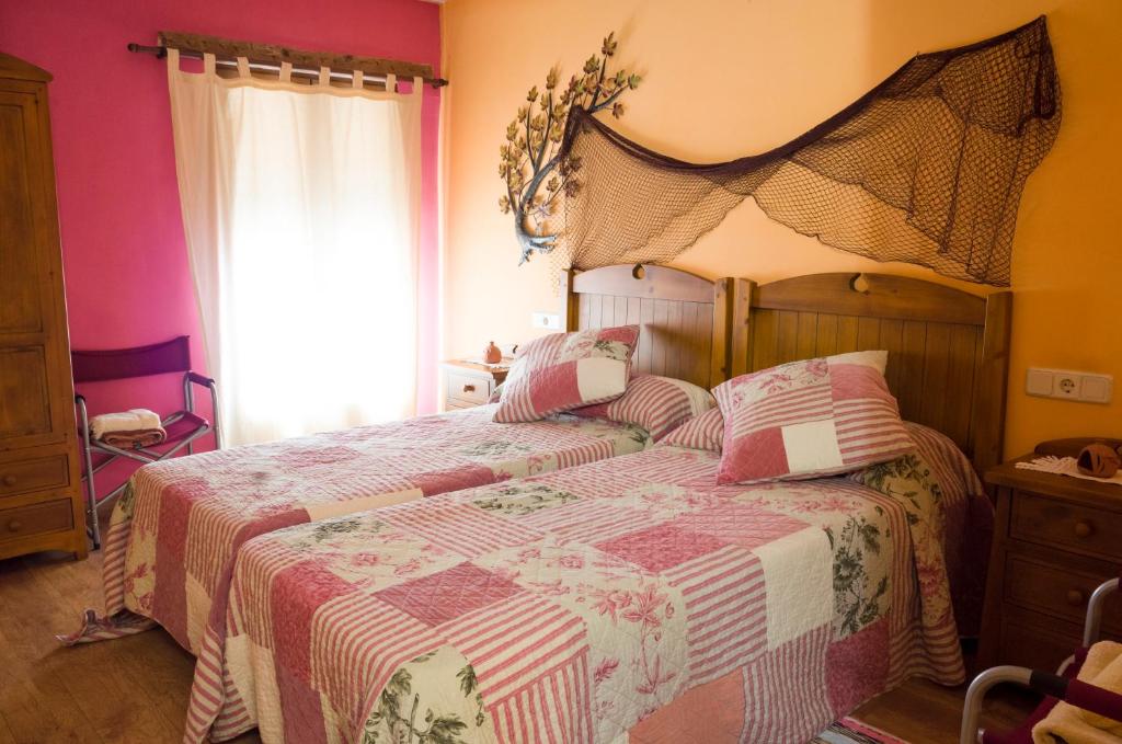 a bedroom with a large bed with a large window at Casa Rural La Pinocha in Sigüenza