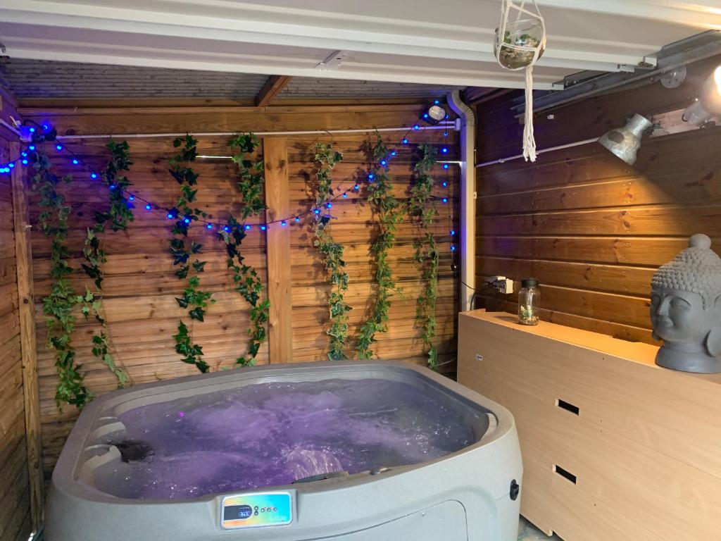 a jacuzzi tub in a room with christmas lights at Bungalow et jacuzzi privatifs in La Possession