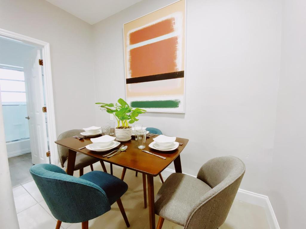 a dining room with a wooden table and chairs at Miami International by Lowkl in Miami Beach
