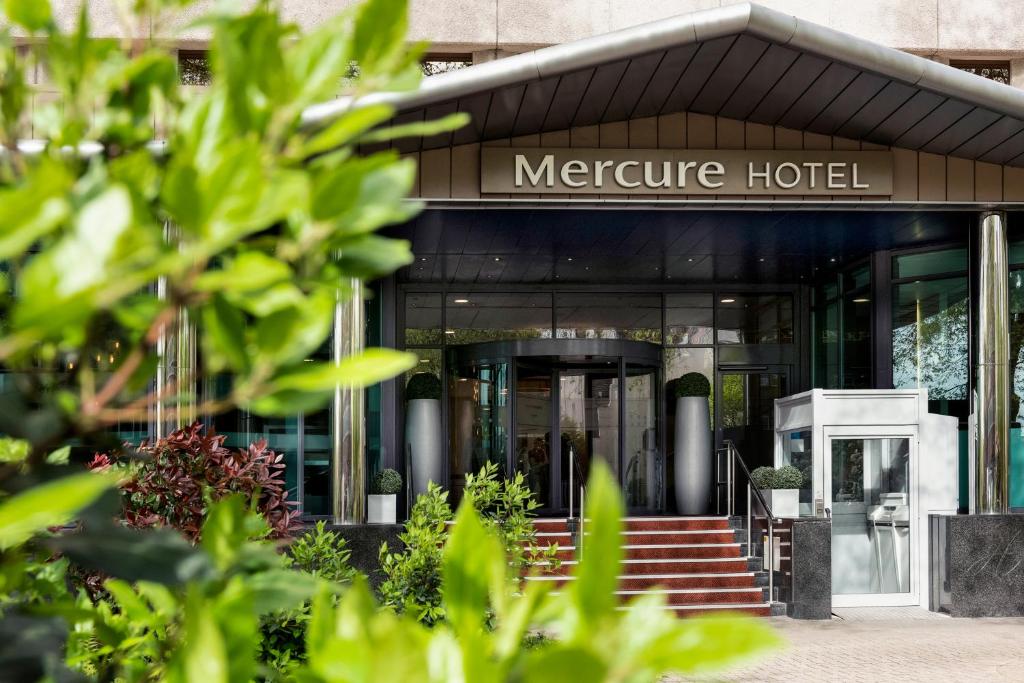 a building with a sign on the front of it at Mercure Bristol Holland House in Bristol